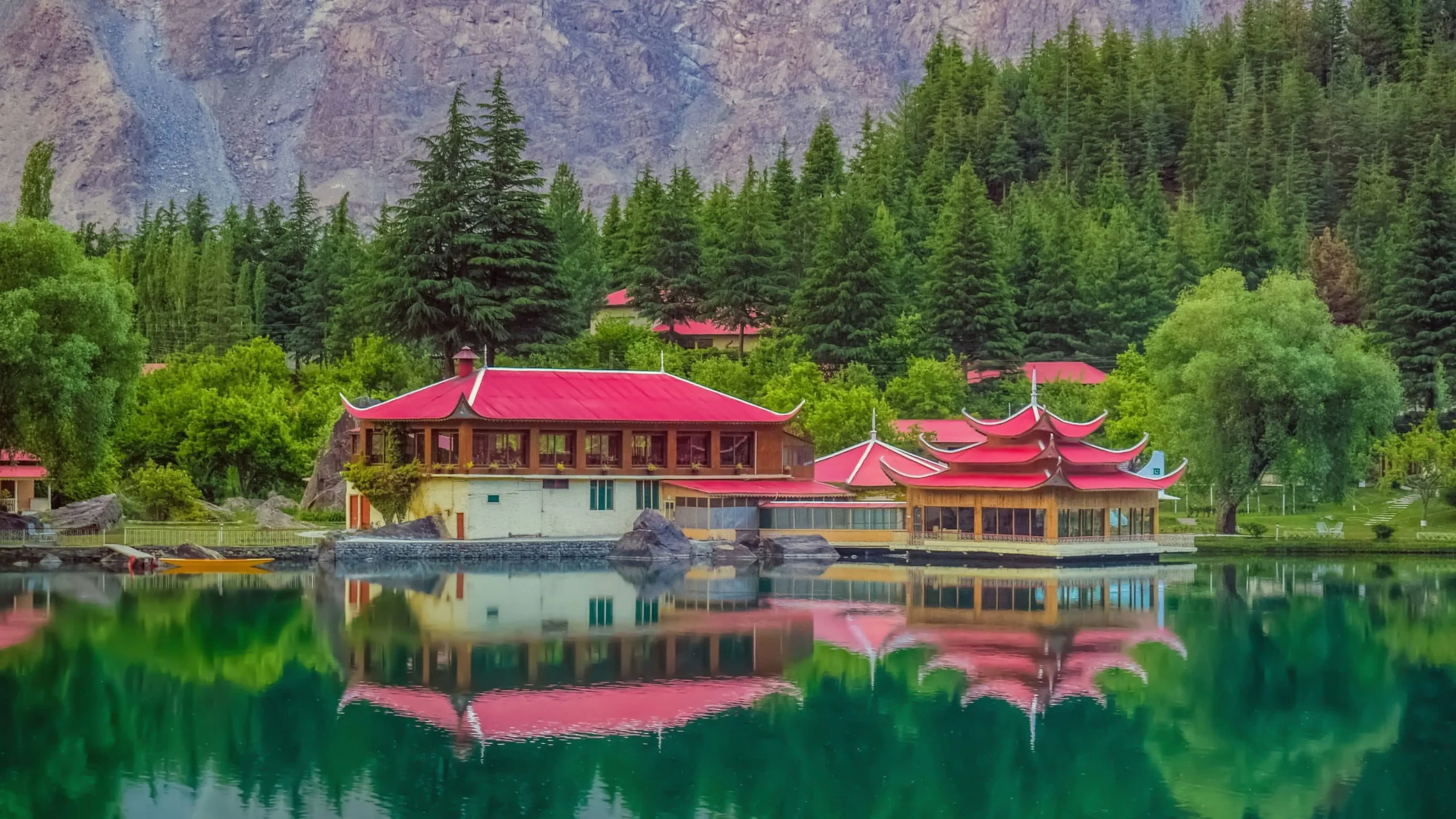 Scenic view of the red-roofed Shangrila Resort and the mirror-like waters of Lower Kachura Lake known as Shangrilla Lake in Skardu Valley, a top travel destination by Northern Discover.