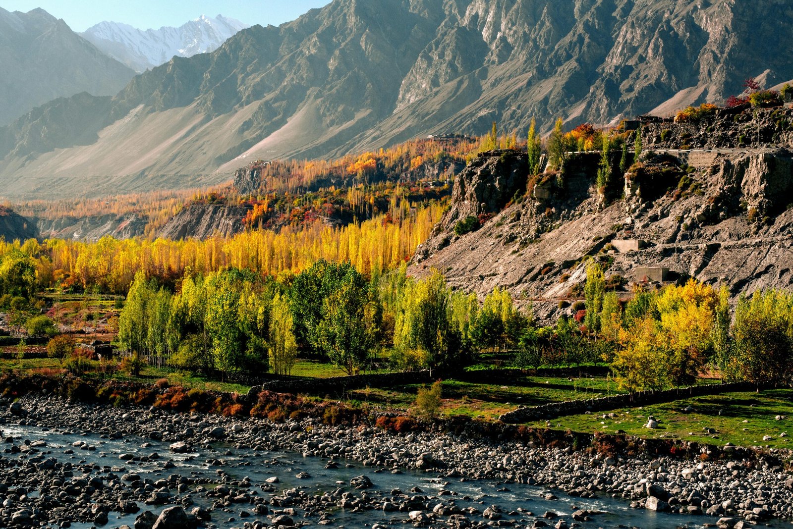 Panoramic view of towering Karakoram mountain peaks and lush green terraces in Hunza Valley, a top travel destination by Northern Discover.