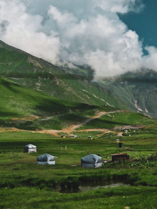 High-altitude green meadows and traditional huts in Chilam Valley, a key transit stop among places to visit in Astore Valley