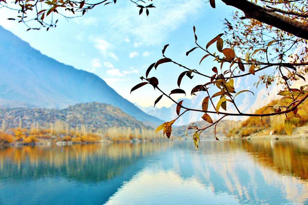 Calm blue waters of Upper Kachura Lake reflecting mountains under a clear sky in Skardu, Gilgit-Baltistan.