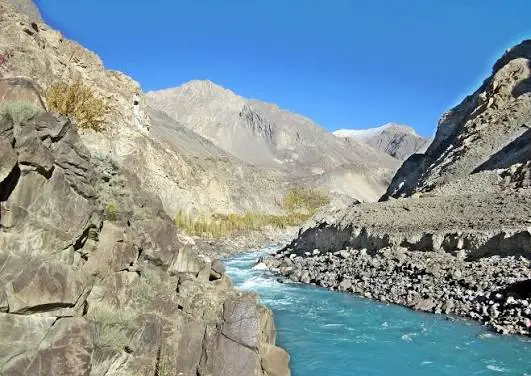 Turquoise river flowing through a rocky mountain valley in northern Pakistan